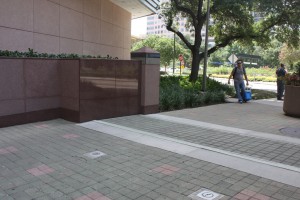 FloodBreak pedestrian floodgate has matching granite sidewalls and is covered with pavers